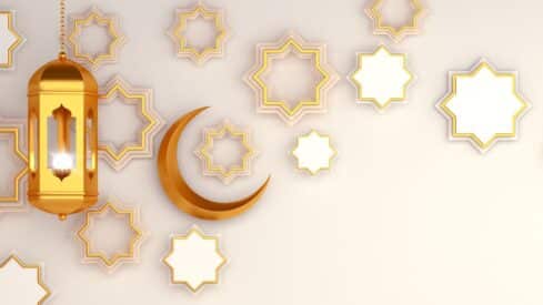 Golden crescent moon and ornate lantern with star patterns on a light background.